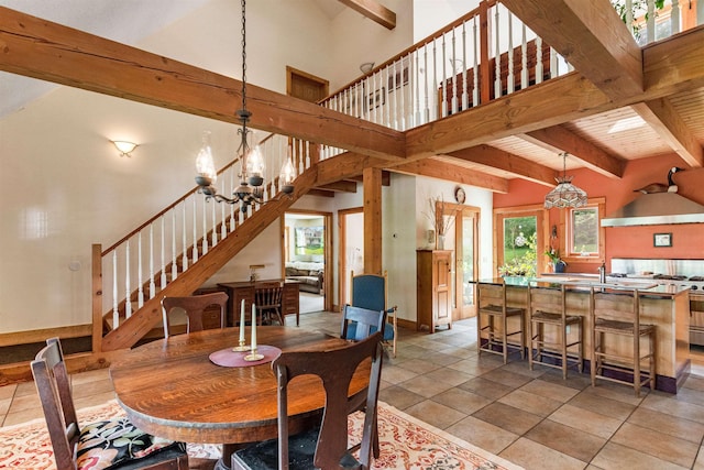 532 Randolph Rd, Stowe, VT 05672 - dining area with stairs, a chandelier, a towering ceiling, beamed ceiling, and light tile patterned floors