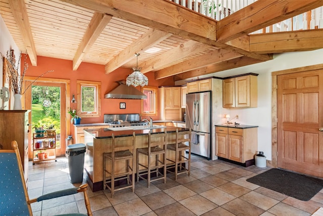 532 Randolph Rd, Stowe, VT 05672 - kitchen featuring stainless steel refrigerator, exhaust hood, light brown cabinets, a center island with sink, and a breakfast bar area