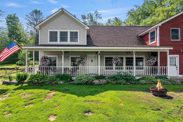 532 Randolph Rd, Stowe, VT 05672 - view of front facade featuring a fire pit, a front yard, roof with shingles, and a porch