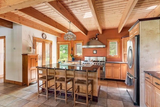 532 Randolph Rd, Stowe, VT 05672 - kitchen with stainless steel appliances, wall chimney range hood, a wood ceiling with exposed beams, dark countertops, and light brown cabinetry