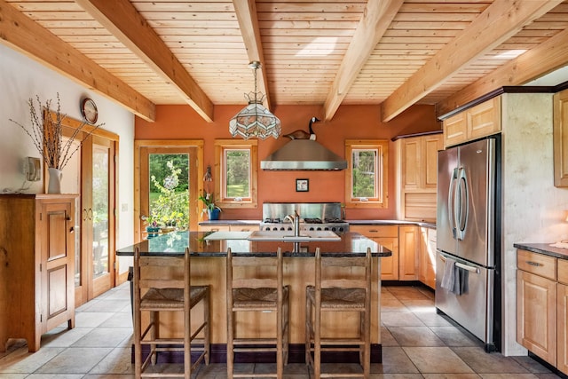 532 Randolph Rd, Stowe, VT 05672 - kitchen featuring freestanding refrigerator, light brown cabinetry, wall chimney range hood, light tile patterned flooring, and a wooden ceiling with exposed beams