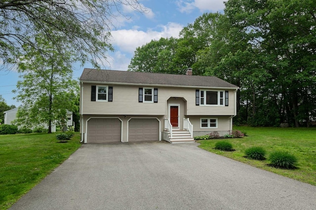 2 Littlehale Rd, Durham, NH 03824 - raised ranch with asphalt driveway, a chimney, an attached garage, and a front yard