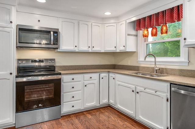 2 Littlehale Rd, Durham, NH 03824 - kitchen with appliances with stainless steel finishes, white cabinetry, dark wood-type flooring, recessed lighting, and light countertops
