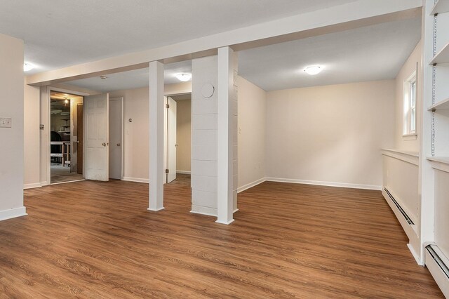 2 Littlehale Rd, Durham, NH 03824 - below grade area featuring a baseboard heating unit and wood finished floors