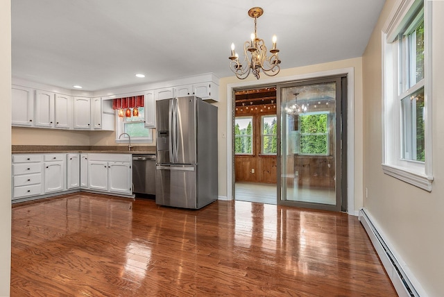 2 Littlehale Rd, Durham, NH 03824 - kitchen with stainless steel appliances, a baseboard heating unit, a chandelier, white cabinetry, and dark wood-style floors