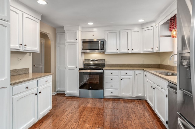 2 Littlehale Rd, Durham, NH 03824 - kitchen with appliances with stainless steel finishes, white cabinets, dark wood-type flooring, and recessed lighting