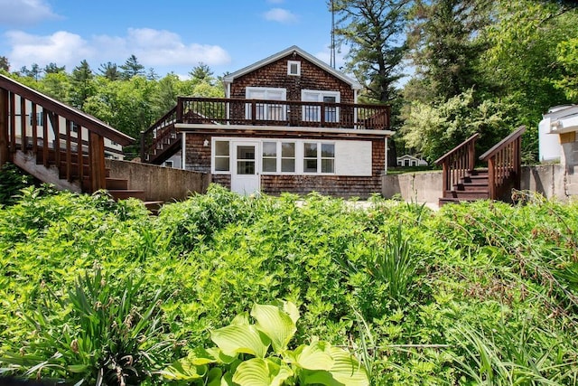 23 Riverlake St, Alton, NH 03810 - back of property with stairway and a wooden deck