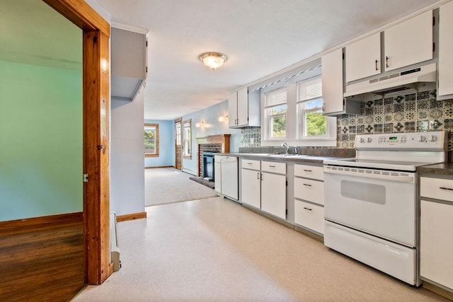 23 Riverlake St, Alton, NH 03810 - kitchen with white appliances, under cabinet range hood, decorative backsplash, a fireplace, and white cabinets
