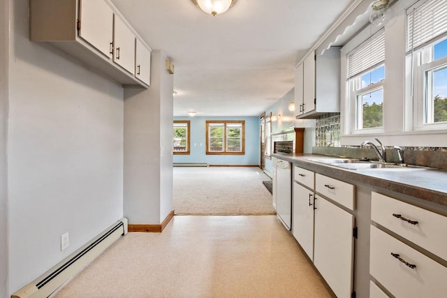 23 Riverlake St, Alton, NH 03810 - kitchen featuring baseboard heating, dark countertops, white dishwasher, white cabinets, and light colored carpet