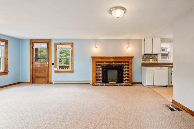 23 Riverlake St, Alton, NH 03810 - unfurnished living room with a baseboard radiator, a fireplace, and light colored carpet