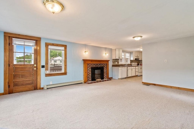 23 Riverlake St, Alton, NH 03810 - unfurnished living room with baseboard heating, light colored carpet, and a brick fireplace