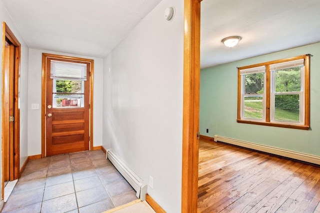 23 Riverlake St, Alton, NH 03810 - doorway with baseboard heating, healthy amount of natural light, and light wood-type flooring
