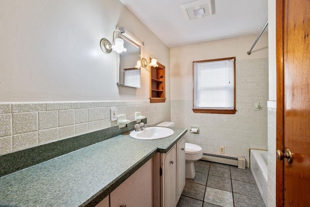 23 Riverlake St, Alton, NH 03810 - full bath featuring a baseboard radiator, tile walls, vanity, tile patterned floors, and bathtub / shower combination