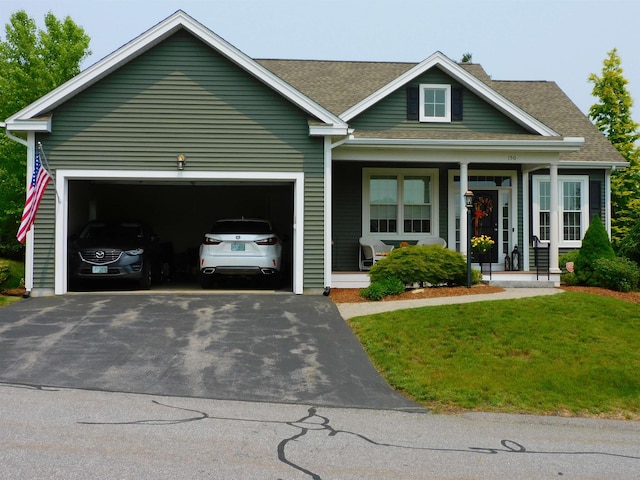 150 Pleasant Pond Way Unit 15, Manchester, NH 03102 - view of front of house with asphalt driveway, a garage, covered porch, roof with shingles, and a front lawn