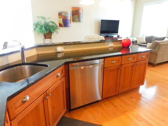 150 Pleasant Pond Way Unit 15, Manchester, NH 03102 - kitchen featuring stainless steel dishwasher, light wood-type flooring, brown cabinets, and open floor plan