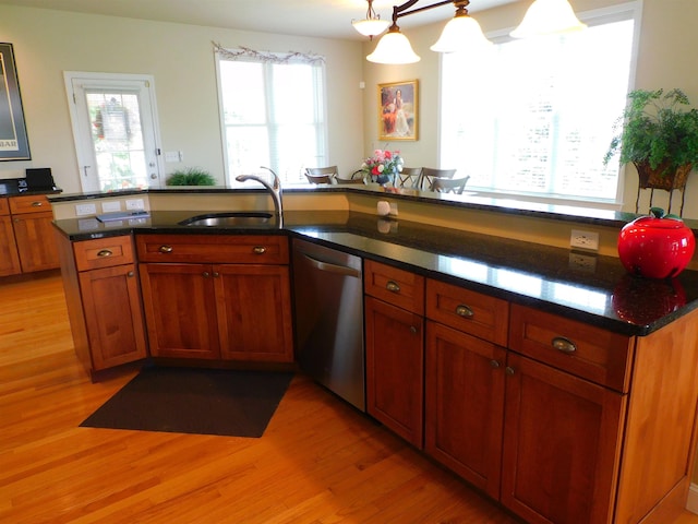 150 Pleasant Pond Way Unit 15, Manchester, NH 03102 - kitchen featuring dishwasher, light wood-style floors, brown cabinets, and dark stone countertops