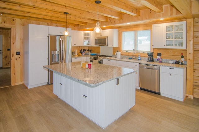 535 Mead Hill Rd, Holland, VT 05830 - kitchen featuring appliances with stainless steel finishes, light wood finished floors, wood walls, white cabinets, and beamed ceiling
