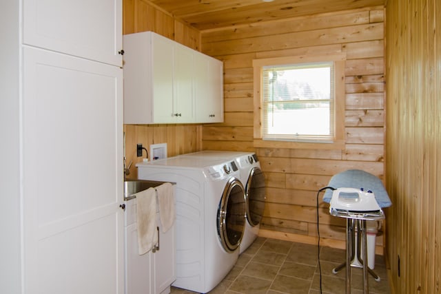 535 Mead Hill Rd, Holland, VT 05830 - washroom featuring cabinet space, wooden walls, washing machine and dryer, and light tile patterned flooring