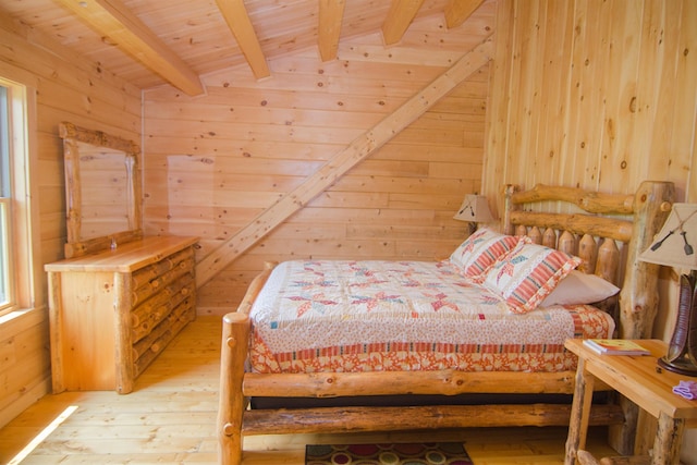535 Mead Hill Rd, Holland, VT 05830 - bedroom with wooden walls, light wood finished floors, and a wooden ceiling with exposed beams