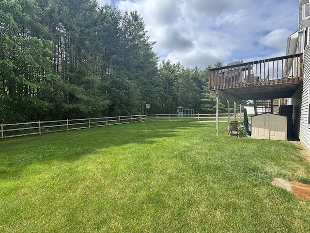 343 Cobblestone Cir S, Burlington, VT 05403 - view of yard featuring a deck, a storage shed, and a forest view