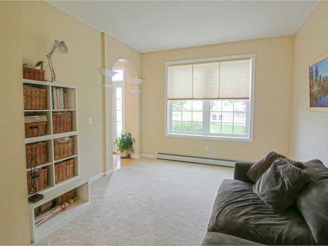343 Cobblestone Cir S, Burlington, VT 05403 - carpeted living room with baseboard heating and arched walkways
