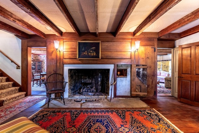 428 N Rd, Salisbury, NH 03235 - living room featuring beamed ceiling, stairway, a large fireplace, wood finished floors, and wood walls