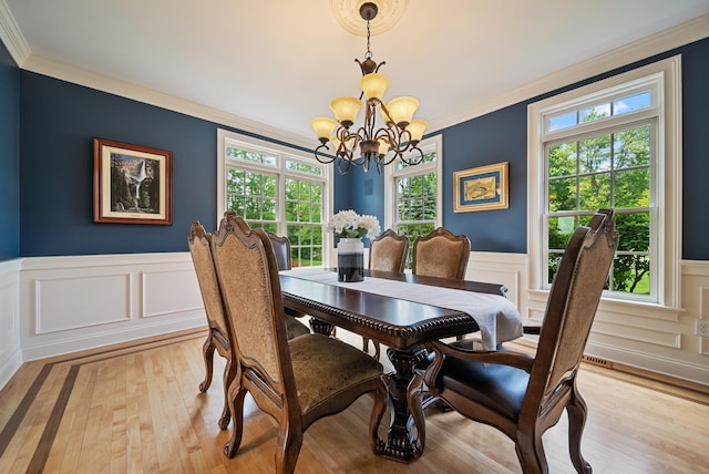 3 Baldwin Ln, Bedford, NH 03110 - dining space featuring a chandelier, light wood-type flooring, crown molding, wainscoting, and a decorative wall
