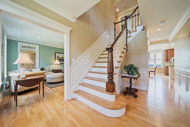 3 Baldwin Ln, Bedford, NH 03110 - stairway with wood finished floors, a decorative wall, ornamental molding, wainscoting, and recessed lighting