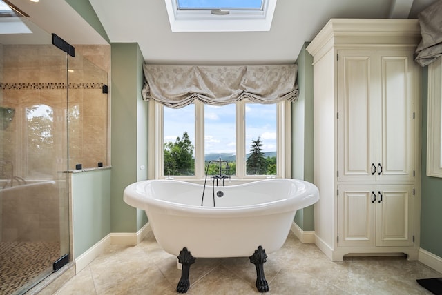 3 Baldwin Ln, Bedford, NH 03110 - full bathroom featuring a skylight, a soaking tub, a shower stall, and tile patterned floors