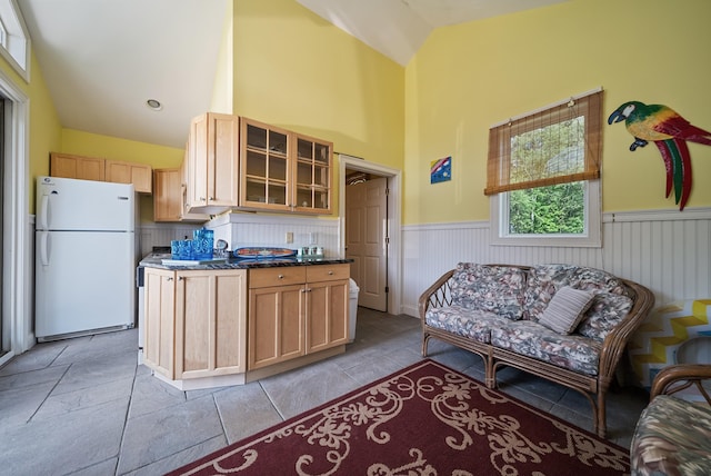 3 Baldwin Ln, Bedford, NH 03110 - kitchen featuring freestanding refrigerator, wainscoting, glass insert cabinets, high vaulted ceiling, and light brown cabinetry