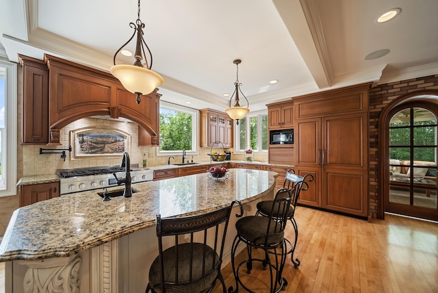 3 Baldwin Ln, Bedford, NH 03110 - kitchen with black microwave, range, tasteful backsplash, crown molding, and light wood finished floors