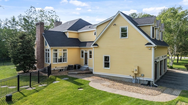3 Baldwin Ln, Bedford, NH 03110 - back of property featuring entry steps, an attached garage, a chimney, a shingled roof, and asphalt driveway