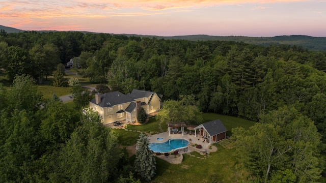 3 Baldwin Ln, Bedford, NH 03110 - aerial view at dusk of a view of trees and view of pool area