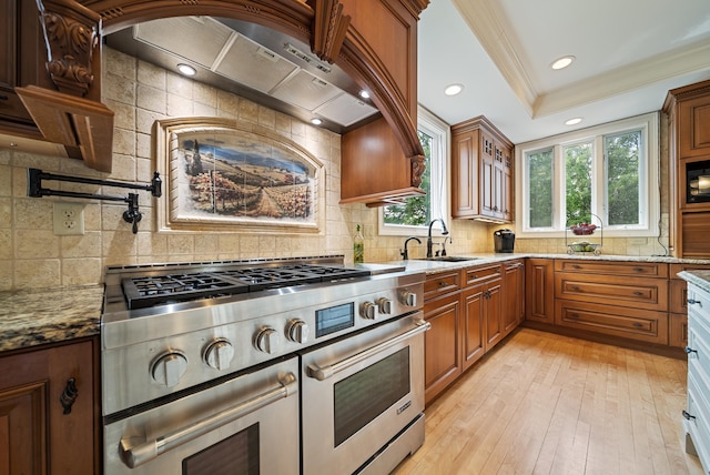 3 Baldwin Ln, Bedford, NH 03110 - kitchen featuring range with two ovens, light stone counters, decorative backsplash, crown molding, and light wood-style floors