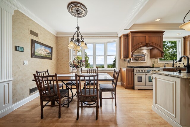 3 Baldwin Ln, Bedford, NH 03110 - dining room with light wood-type flooring, crown molding, and a chandelier