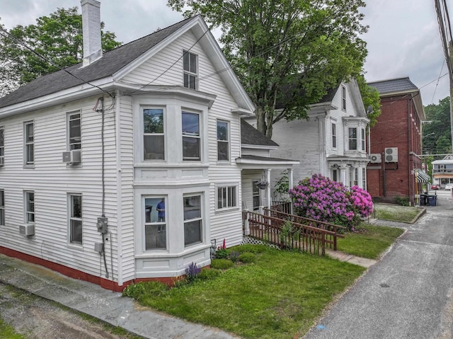 5 School St, Tilton, NH 03276 - view of front facade featuring a chimney and cooling unit