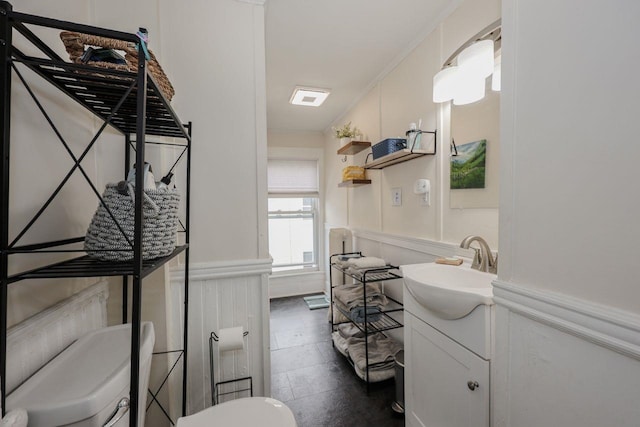 5 School St, Tilton, NH 03276 - half bath with a decorative wall, vanity, and wainscoting