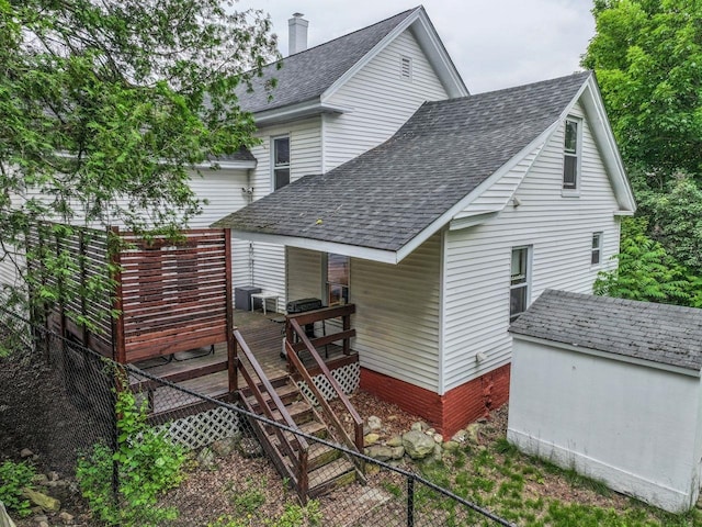 5 School St, Tilton, NH 03276 - back of house with a shingled roof, a chimney, a wooden deck, stairs, and a shed