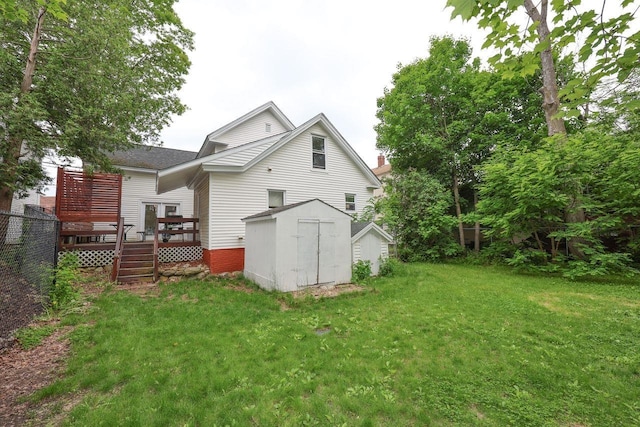 5 School St, Tilton, NH 03276 - rear view of house with a storage shed, a deck, and a lawn