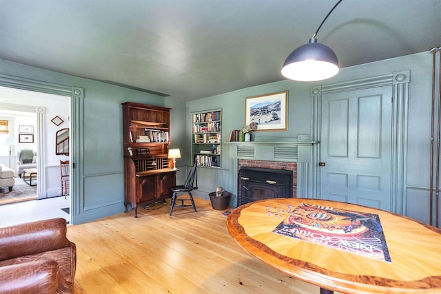 121 Main St, New Ipswich, NH 03071 - home office featuring a fireplace, hardwood / wood-style floors, and built in shelves
