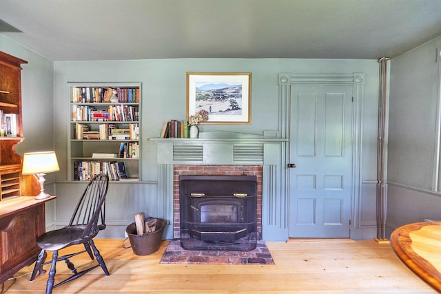 121 Main St, New Ipswich, NH 03071 - living area featuring wood finished floors, a wood stove, and built in shelves
