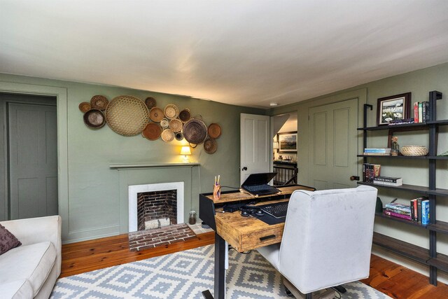 121 Main St, New Ipswich, NH 03071 - home office with wood finished floors and a brick fireplace