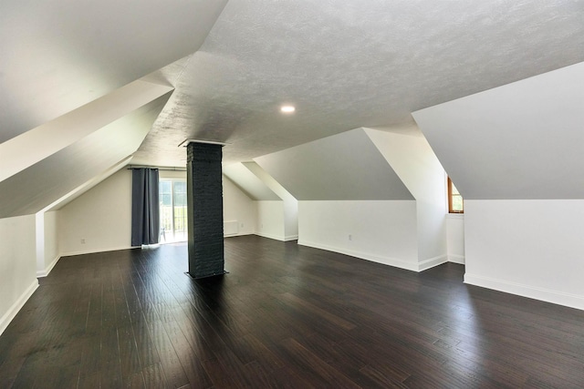 121 Main St, New Ipswich, NH 03071 - bonus room with vaulted ceiling, wood-type flooring, a textured ceiling, and decorative columns
