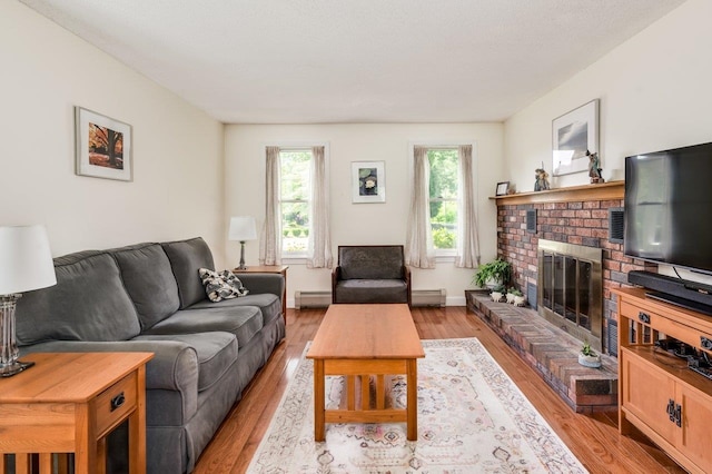 1 Constable Rd, Durham, NH 03824 - living area featuring light wood-style floors, a baseboard heating unit, and a brick fireplace