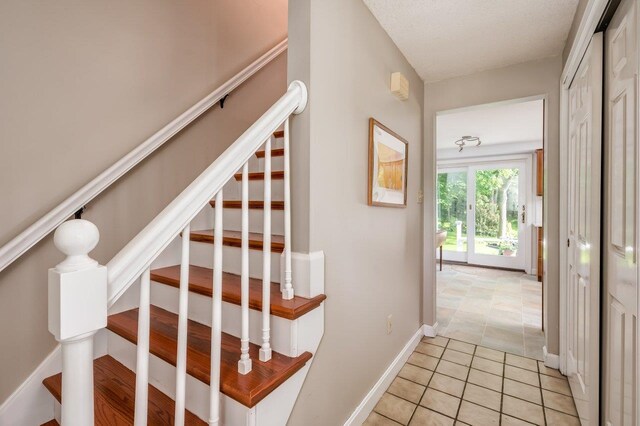 1 Constable Rd, Durham, NH 03824 - stairway with baseboards and tile patterned flooring
