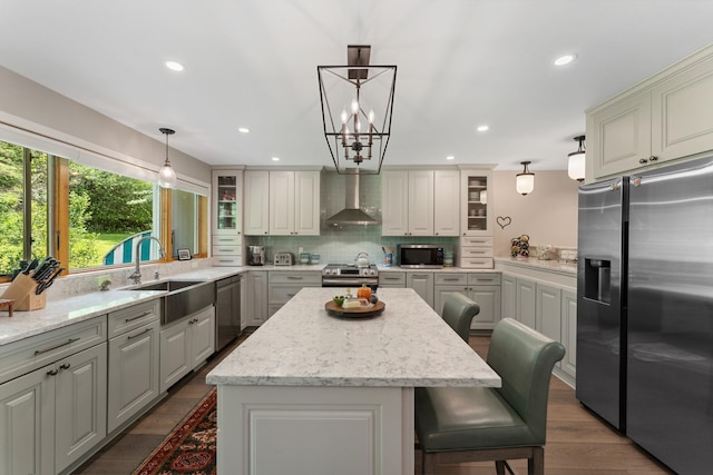 149 Club Sugarbush N Rd, Warren, VT 05674 - kitchen with stainless steel appliances, wall chimney exhaust hood, a center island, decorative backsplash, and glass insert cabinets
