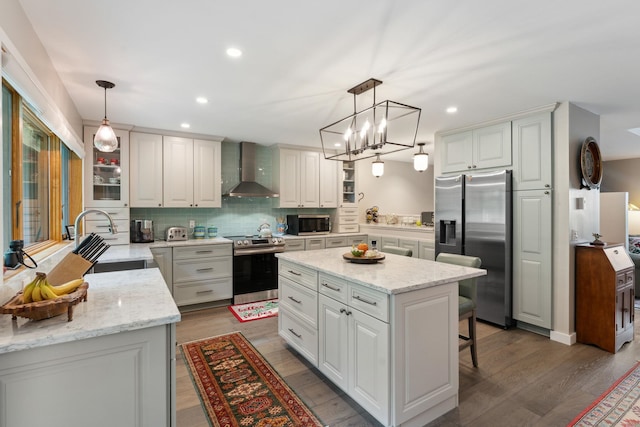 149 Club Sugarbush N Rd, Warren, VT 05674 - kitchen with wall chimney range hood, appliances with stainless steel finishes, a kitchen island, recessed lighting, and decorative backsplash