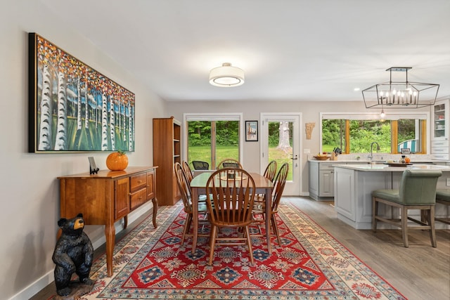 149 Club Sugarbush N Rd, Warren, VT 05674 - dining room with light wood-style flooring, healthy amount of natural light, and a chandelier