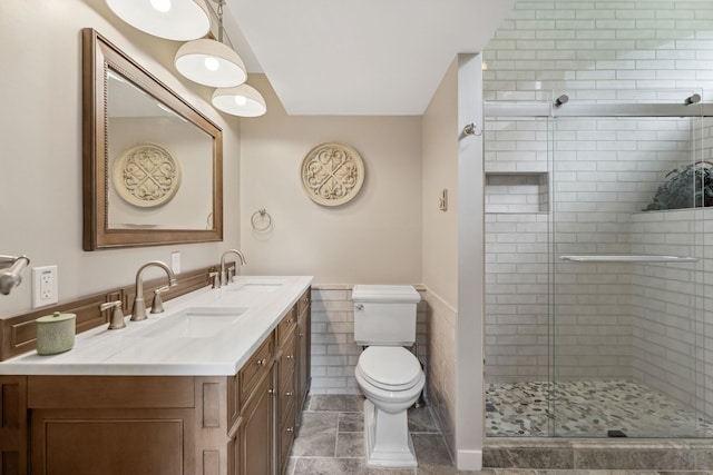 149 Club Sugarbush N Rd, Warren, VT 05674 - bathroom with vanity, a shower stall, tile walls, and wainscoting