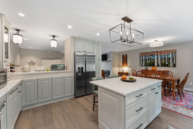 149 Club Sugarbush N Rd, Warren, VT 05674 - kitchen with stainless steel fridge, light wood finished floors, a center island, hanging light fixtures, and recessed lighting